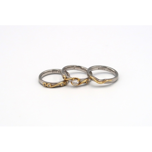 75 - A set of three platinum and gold rings to include one set with a brilliant cut diamond, estimated 0.... 