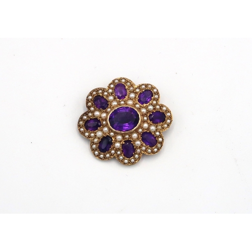 97 - A 9ct yellow gold amethyst and seed pearl brooch of floral design - approx weight 10.05 grams