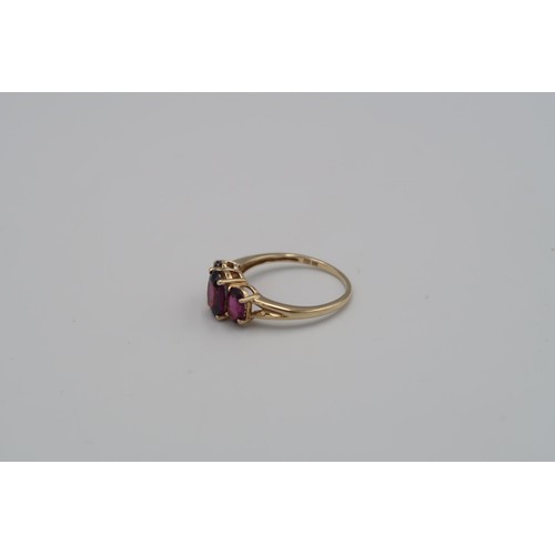 177 - A 9ct yellow gold three stone Almandine garnet ring - garnets are a good colour and well matched - h... 