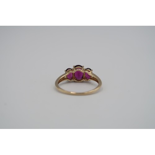 177 - A 9ct yellow gold three stone Almandine garnet ring - garnets are a good colour and well matched - h... 