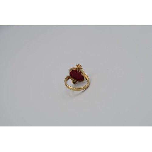 159 - A 9ct Yellow Gold Dress ring with Oval cut red gemstone to shoulder Size R - approx weight 6.3 grams