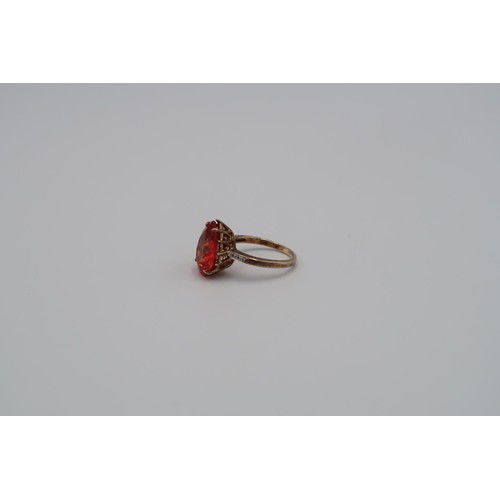 163 - A 9ct Yellow Gold Dress ring with large tear shaped red gemstone to shoulder. Size R - approx weight... 