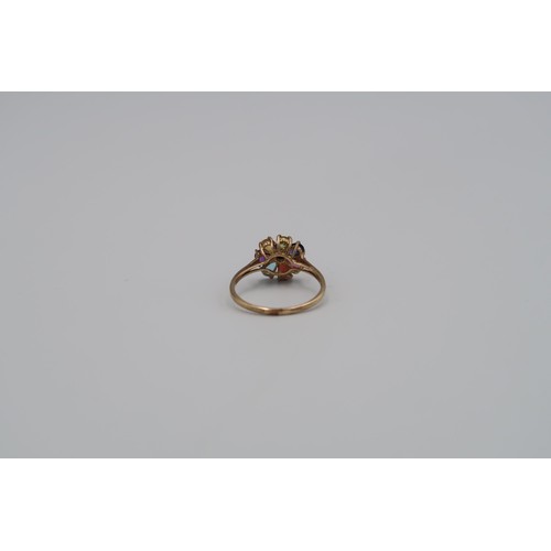 165 - A 9ct Yellow Gold Flower head dress ring, with alternate coloured gemstones to shoulder. Size R - ap... 