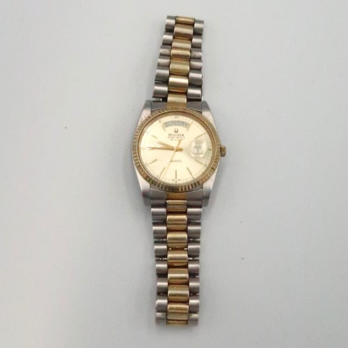 254 - A Bulova Super Seville day and date watch on a bi metal strap - running in the saleroom