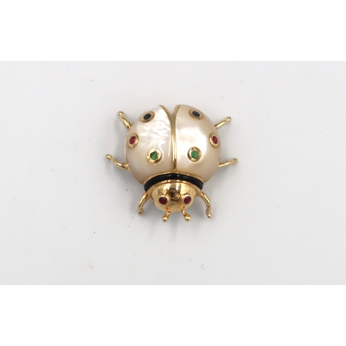 120 - A mother of pearl ladybird brooch with stone collets and black enamel detail. Stamped 14K. Length 27... 