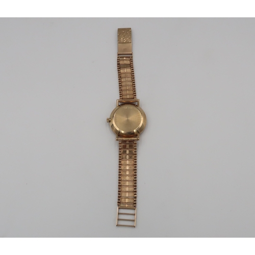 253 - A gents 9ct gold cased Omega automatic on 9ct gold strap with baton markers to champagne coloured di... 