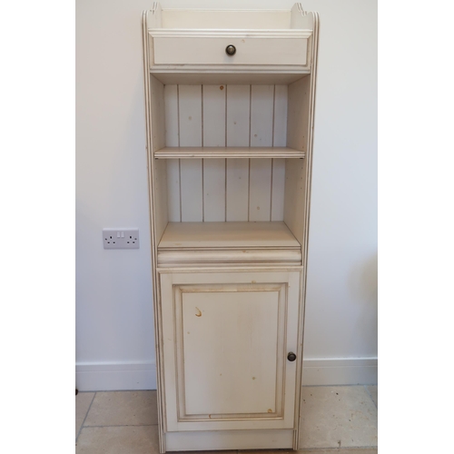 629 - A Ducal Distressed pine cupboard, drawer over shelves above door. 156cm high x 29cm deep x 39cm wide... 