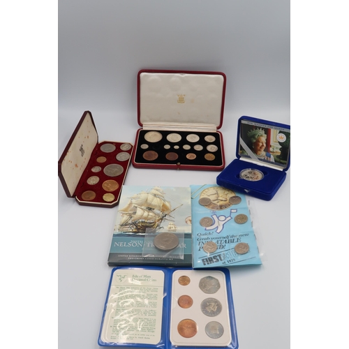 412 - A selection of Coinage, some commemorative, other include silver shillings. First Isle of Man £1 coi... 