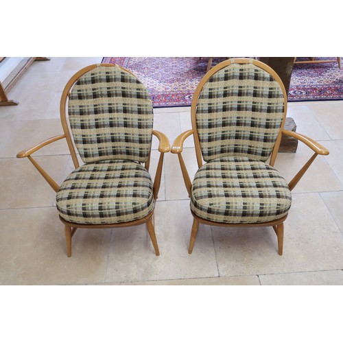 644 - A pair of Ercol stick back armchairs