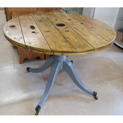 663 - A Reclaimed round top pedestal table, raised on tripod supports. Dia. 99cm x 75cm high.