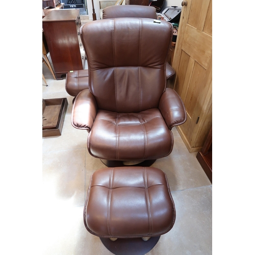 657 - A stressless style brown leather upholstered armchair with matching stool.