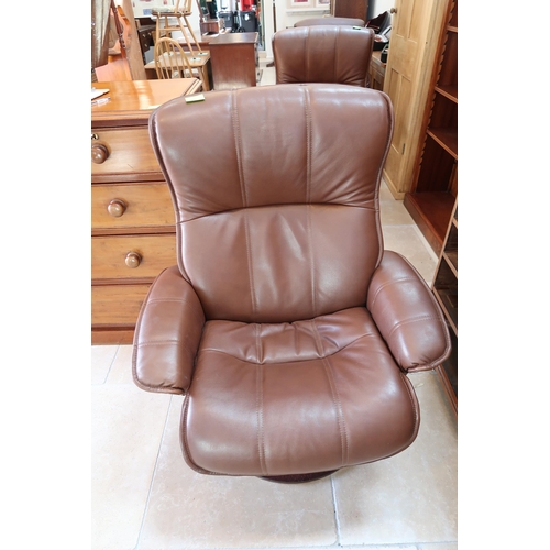 658 - A Stressless style brown leather upholstered armchair with matching stool.