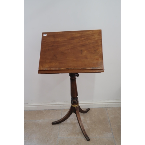 666 - A Victorian mahogany adjustable music or reading stand raised on turned column terminating in tripod... 