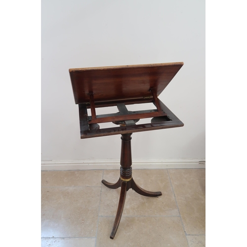 666 - A Victorian mahogany adjustable music or reading stand raised on turned column terminating in tripod... 