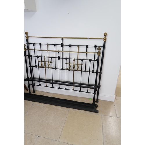 675 - A Brass and Iron double bed frame. Early 20th Century.