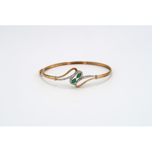 76 - A diamond and green gem bangle. Stamped 9ct. Weight approx 4.83 grams.