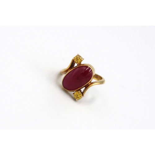 78 - A 9ct Yellow Gold Dress ring with Oval cut red gemstone to shoulder Size R - approx weight 6.3 grams