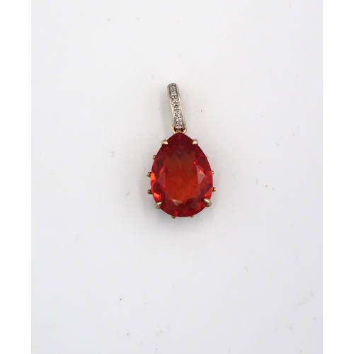 83 - A 9ct yellow gold pendant with tear shaped red gemstone to centre, on a white and yellow gold suspen... 