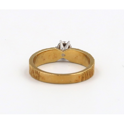 16 - An 18ct Yellow Gold Solitaire ring with moissanite stone to shoulder 4.96 grams. Size