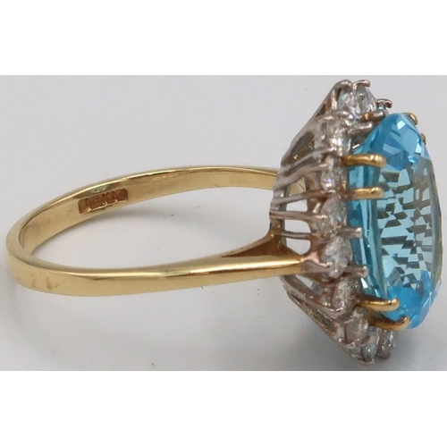 28 - An 18ct Yellow gold blue topaz and diamond cluster ring. Size Q/R 4.0 grams