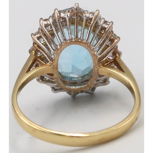 28 - An 18ct Yellow gold blue topaz and diamond cluster ring. Size Q/R 4.0 grams