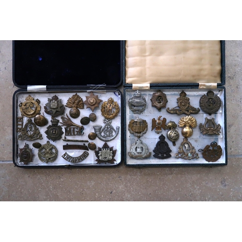 508 - Two boxes of military cap badges.