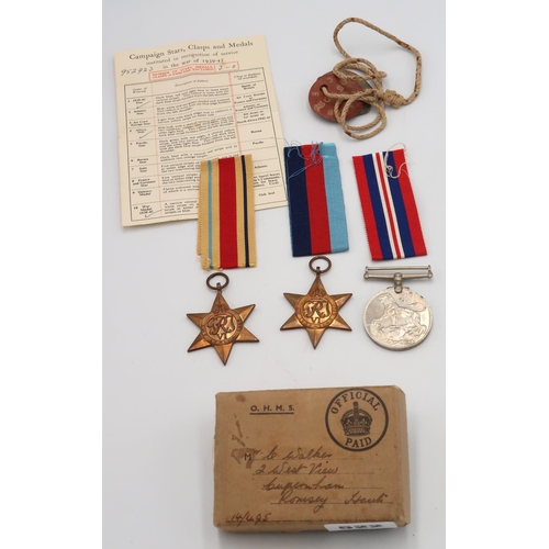 522 - A O.H.M.S. box containing medal award paperwork for L Walker. including dog tags 1939-45 War medal, ... 