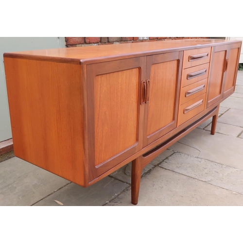 631 - A Mid 20th Century G-Plan Fresco sideboard, Four central drawers flaked by four doors. 213cm long x ... 