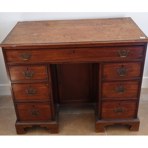 634 - A Georgian mahogany kneehole desk with a central cupboard door, 104cm wide x 85cm high x 54cm deep