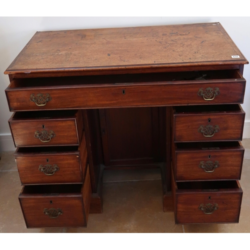 634 - A Georgian mahogany kneehole desk with a central cupboard door, 104cm wide x 85cm high x 54cm deep