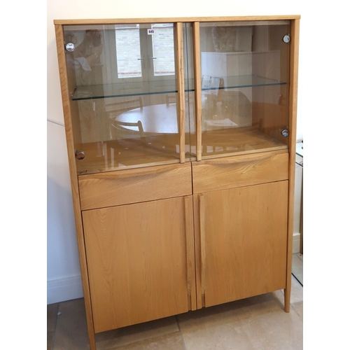 645 - An Ercol Pinter glazed cabinet Ref 877 30635 height 150cm x width 100cm x depth 45cm.