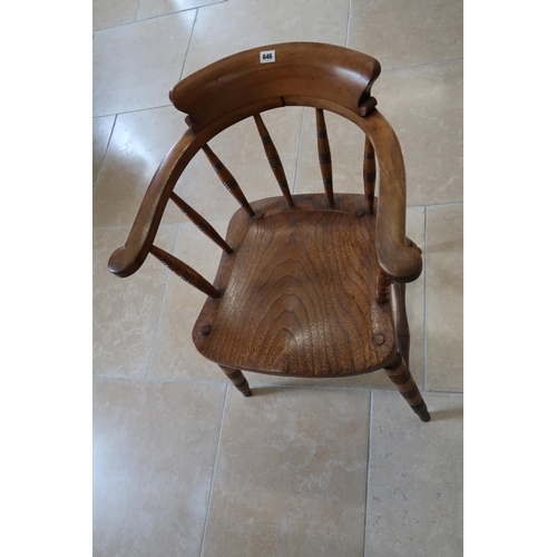 646 - An oak and elm Windsor chair raised on turned supports joined by stretcher.