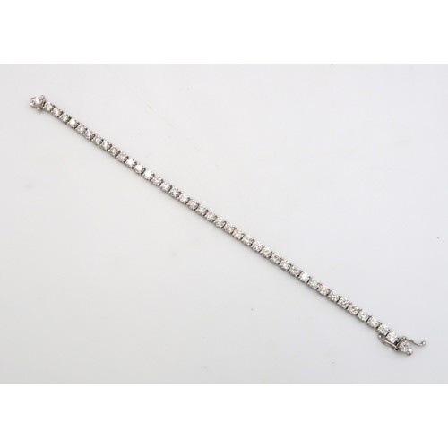 40 - A brilliant cut diamond tennis bracelet. Estimated total weight 6.56cts. Estimated G/H colour, SI1/S... 