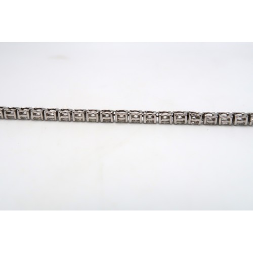 40 - A brilliant cut diamond tennis bracelet. Estimated total weight 6.56cts. Estimated G/H colour, SI1/S... 