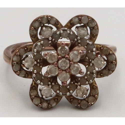 78 - A brilliant cut diamond flower head ring, stamped 925, size P, weight 4.27 grams