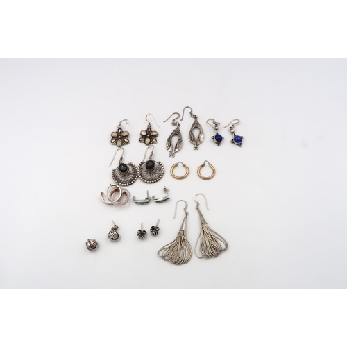 65 - Ten pairs of assorted earrings. One pair set with emeralds. Most with marks indicating silver. Weigh... 