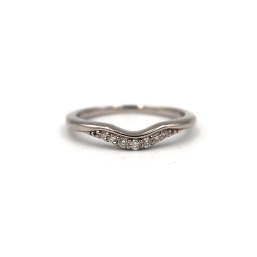 163 - A platinum and diamond wishbone ring. Size J 1/2. Weight 1.37 grams