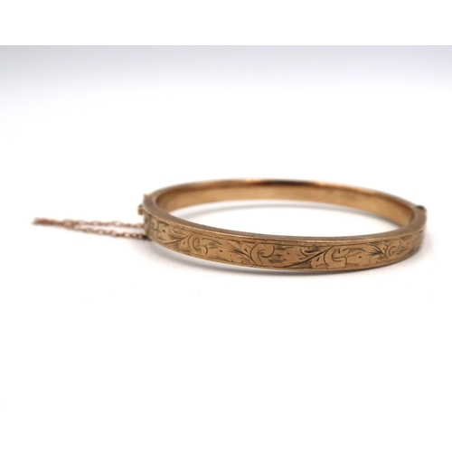 165 - A 9ct gold hinged bangle. Weight 7.45 grams.