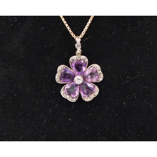 166 - An amethyst and diamond flower pendant. With central brilliant cut diamond estimated 0.15ct, surroun... 