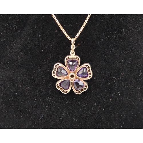 166 - An amethyst and diamond flower pendant. With central brilliant cut diamond estimated 0.15ct, surroun... 