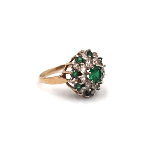 169 - A 9ct gold green and white paste stone cluster ring. Size N 1/2. Weight 3.11 grams.