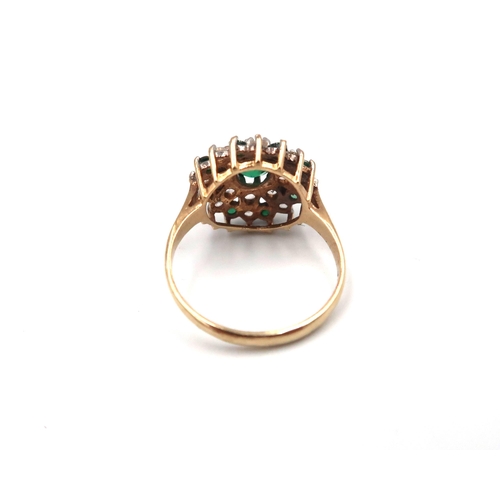 169 - A 9ct gold green and white paste stone cluster ring. Size N 1/2. Weight 3.11 grams.