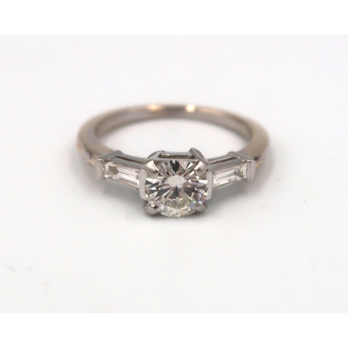 179 - An 18ct gold diamond ring, the centre stone approx 0.80ct, colour approx G/H, VS1 with tapered bague... 