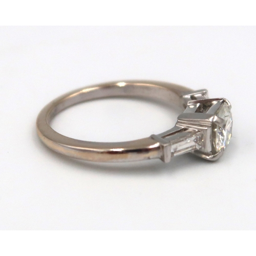 179 - An 18ct gold diamond ring, the centre stone approx 0.80ct, colour approx G/H, VS1 with tapered bague... 