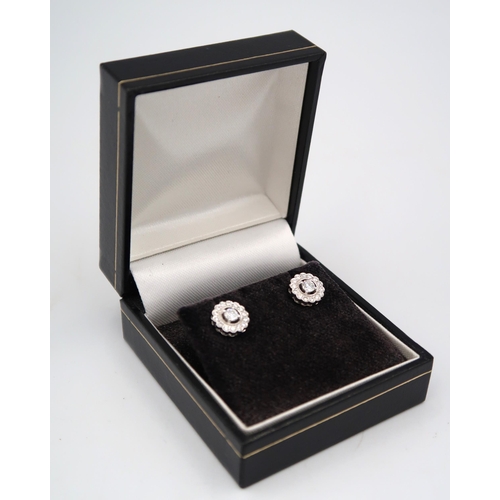 184 - A pair of good quality 18ct white gold diamond cluster earrings - retailed by Luke Stockley of Londo... 