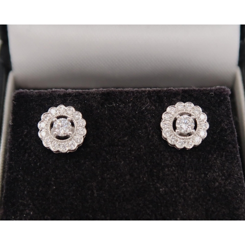 184 - A pair of good quality 18ct white gold diamond cluster earrings - retailed by Luke Stockley of Londo... 