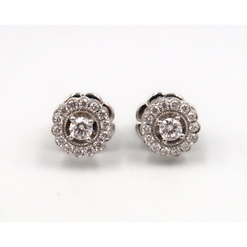 184 - A pair of good quality 18ct white gold diamond cluster earrings - retailed by Luke Stockley of Londo... 