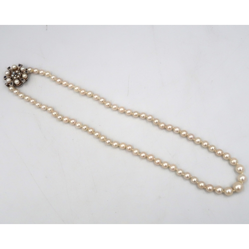 188 - A pearl necklace with a 9ct white gold sapphire and pearl clasp - head size approx 21mm - approx len... 