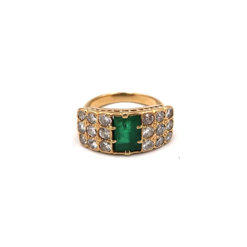 193 - An unmarked, possibly 18ct, yellow gold, emerald and diamond ring, the baguette cut emerald flanked ... 