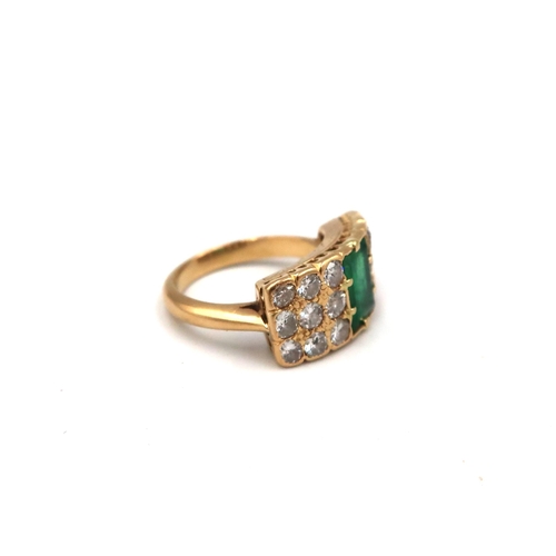 193 - An unmarked, possibly 18ct, yellow gold, emerald and diamond ring, the baguette cut emerald flanked ... 